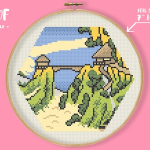 May include: Cross stitch pattern of a whimsical landscape with two small houses, a bridge, and green trees. The pattern is designed to fit in a 7-inch embroidery hoop.