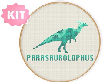 May include: A cross-stitch kit featuring a green Parasaurolophus dinosaur with a leafy pattern. The kit includes a hoop and embroidery floss.