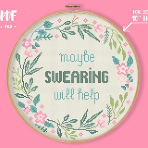 Puede incluir: Un patrón de punto de cruz con una corona de flores y el texto "maybe swearing will help" en un aro de 25 cm.