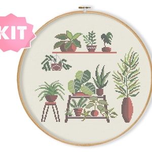 May include: A cross-stitch pattern featuring a collection of potted plants in various shades of green, brown, and terracotta. The plants are arranged on a shelf and a small stool, creating a charming and modern botanical display.