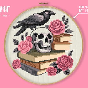 May include: Cross-stitch design featuring a skull, crow, and pink roses atop stacked books. The design is set within a 10-inch embroidery hoop. The text "PDF FILE" is at the top left.