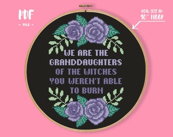 May include: A cross-stitch design on a 10-inch hoop with the text "WE ARE THE GRANDDAUGHTERS OF THE WITCHES YOU WEREN'T ABLE TO BURN". The design features purple roses and green leaves on a black background. The PDF file is available.