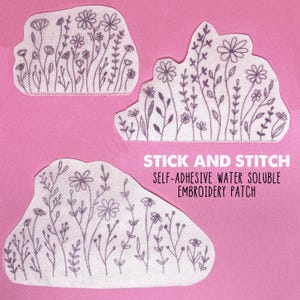 Pode incluir: Três patches de bordado hidrossolúveis brancos com um design floral. Os patches são etiquetados como "Stick and Stitch Self-Adhesive Water Soluble Embroidery Patch".