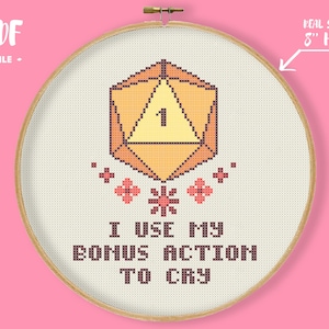 May include: Cross-stitch design in a wooden hoop. The design features a pixelated D20 die with the number 1, floral accents, and the text "I USE MY BONUS ACTION TO CRY." The hoop is 5 inches in diameter.
