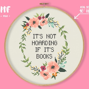 May include: A cross-stitch pattern featuring a floral wreath with the text "It's not hoarding if it's books". The pattern is designed for a 10-inch hoop.
