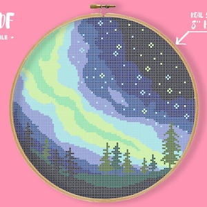 May include: A cross-stitch pattern of a night sky with a green and blue aurora borealis, a dark forest silhouette, and a scattering of white stars. The pattern is displayed in an 8-inch embroidery hoop.