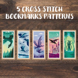 May include: Five cross-stitch bookmark patterns are displayed on a wooden surface. Each bookmark features a different dragon design in various colours, including green, blue, and purple. The text "5 CROSS STITCH BOOKMARKS PATTERNS" is at the top.