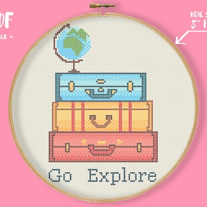 May include: Cross-stitch design featuring a globe atop three stacked suitcases in blue, yellow, and red. The words "Go Explore" are stitched below. The design is displayed in an 8-inch hoop, perfect for travel enthusiasts.