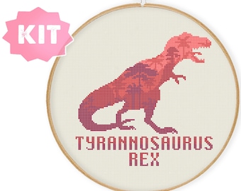 May include: Cross stitch kit featuring a pink and purple silhouette of a Tyrannosaurus Rex with the text "Tyrannosaurus Rex" underneath.
