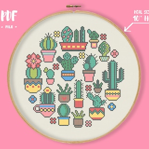 May include: A cross-stitch pattern featuring various cacti in colorful pots, arranged in a circular design. The design is set within a 10-inch embroidery hoop, with the text "PDF FILE" at the top left and "REAL SIZE IN 10" HOOP" on the right.