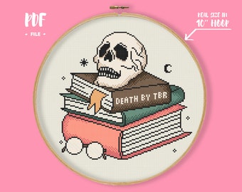 May include: Cross-stitch pattern featuring a skull wearing a brown hat and reading a stack of books. The top book has the text "DEATH BY TBR" on the cover. The pattern is designed for a 10-inch hoop.