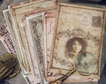 May include: A stack of vintage-style postcards with ornate borders and a faded image of a woman. The top postcard has a stamp that reads "POST CARD" and "4P." The postcards are on a brown surface with a magnifying glass.