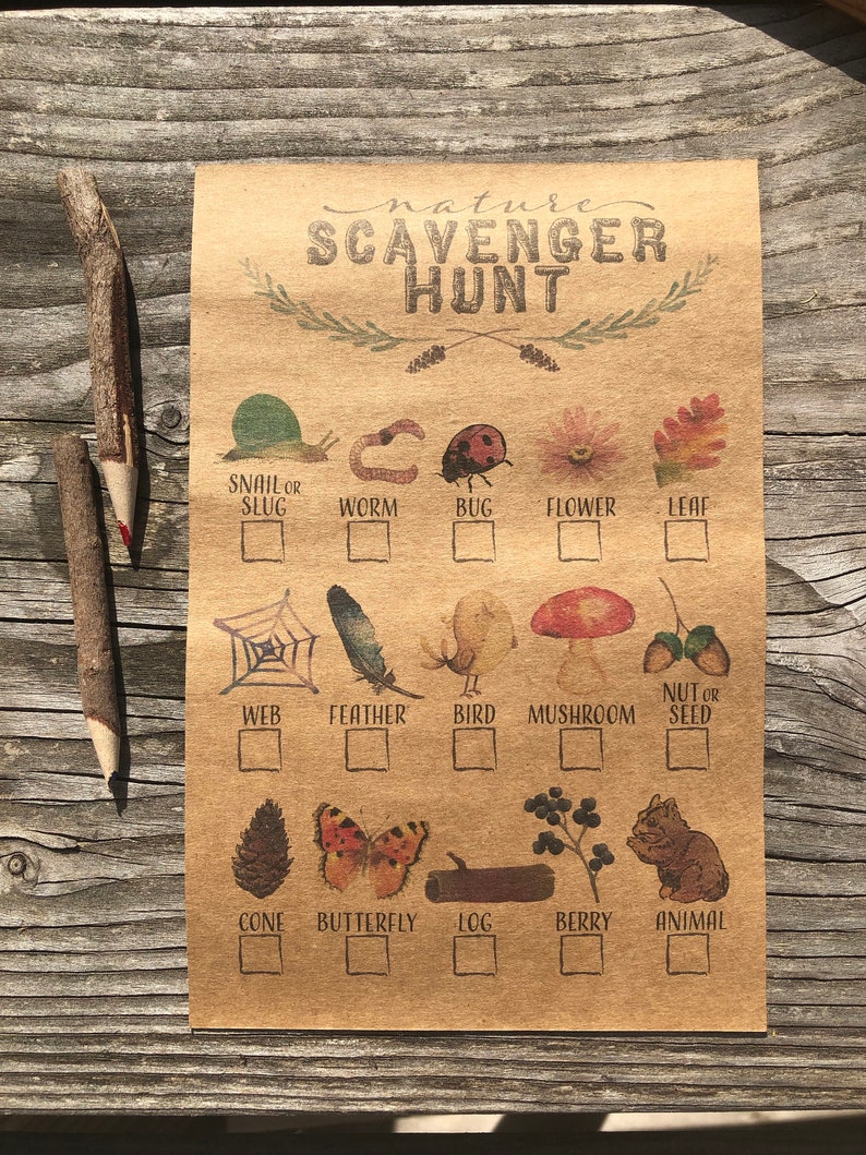 May include: A brown paper card with the text "nature scavenger hunt" printed in black cursive. The card has a checklist of 12 nature items to find, including a snail, worm, bug, flower, leaf, web, feather, bird, mushroom, nut or seed, cone, butterfly, log, berry, and animal. Each item is illustrated with a small image.