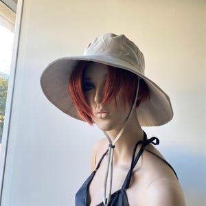 hand made natural linen hat on mannequin
