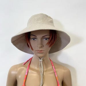 natural linen wide brim hat on mannequin