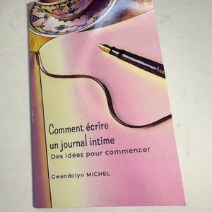 May include: A pink and yellow book cover with the title "Comment écrire un journal intime" and the subtitle "Des idées pour commencer". The author's name is "Gwendolyn MICHEL".