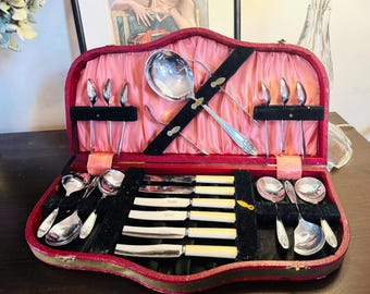 large box with jelly spoons, butter knives, teaspoons and servers
