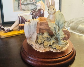 Beatrix Potter 'Peter Rabbit' in a WheelBarrow on a wooden plinth
