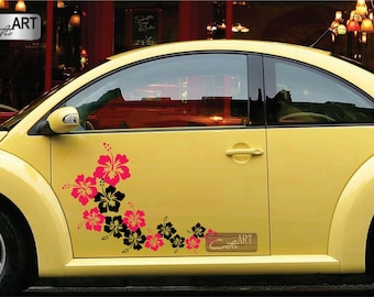 May include: A yellow car features a vinyl decal on the driver side door. The decal consists of a cluster of hibiscus flowers in alternating solid black and bright pink colours, arranged in a diagonal pattern. A small rectangular logo reads Coelio ART.