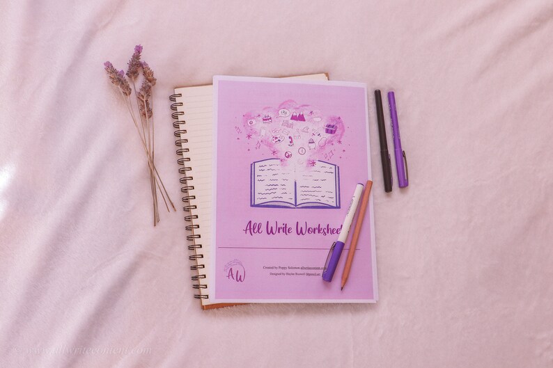 May include: A pink and purple worksheet titled "All Write Worksheet" with a drawing of an open book and a cloud of colorful icons. The worksheet is on a white surface with a spiral bound notebook, a pencil, and three pens.