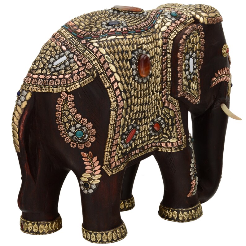 May include: A dark brown wooden elephant figurine with intricate gold and copper embellishments, including colorful gemstones. The elephant is decorated with paisley patterns and has a raised trunk.