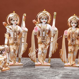 May include: White marble statue set of the Hindu deities Rama, Sita, Lakshmana, and Hanuman. The statues are intricately carved and painted with gold accents. The set is a beautiful representation of the Ramayana epic.