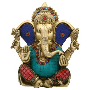 May include: A gold-colored brass statue of Ganesha, the Hindu god of wisdom and prosperity. The statue is intricately detailed with turquoise, red, and blue gemstones. Ganesha is depicted with an elephant head, four arms, and a large belly.