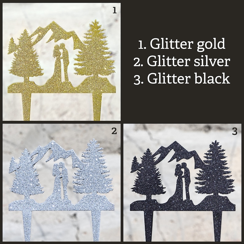 May include: A cake topper featuring a couple standing in front of a mountain range with two pine trees on either side. The topper is available in three colors: glitter gold, glitter silver, and glitter black.