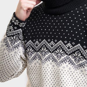 Peut inclure: Un pull &agrave; col roul&eacute; noir et blanc &agrave; motifs. Le pull a un col roul&eacute; noir et un motif blanc et gris sur la moiti&eacute; inf&eacute;rieure.