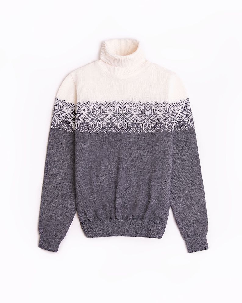 May include: A gray and white turtleneck sweater with a geometric pattern around the chest.