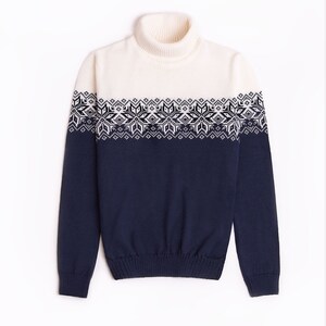May include: A white and navy blue turtleneck sweater with a geometric pattern around the chest.
