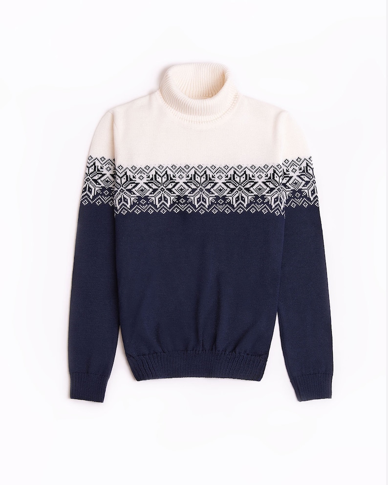 May include: A white and navy blue turtleneck sweater with a geometric pattern around the chest.