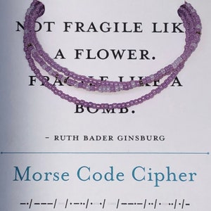 May include: A purple beaded bracelet with the quote "Not fragile like a flower, fragile like a bomb." by Ruth Bader Ginsburg and the Morse code translation of the quote.