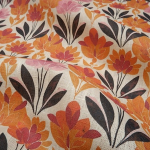 May include: A beige fabric with a repeating pattern of stylised flowers in shades of orange, pink, and red. The flowers have a retro, mid-century modern aesthetic.