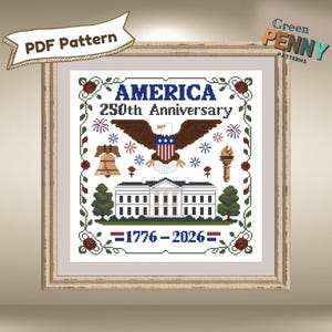 May include: Cross-stitch pattern celebrating America's 250th Anniversary. The design features an eagle, the White House, a bell, a torch, and the text "AMERICA 250th ANNIVERSARY" and "1776-2026". The pattern is framed in a wooden frame.