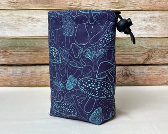 May include: A dark purple drawstring bag with a blue and white mushroom print. The bag has a black drawstring and a black toggle.