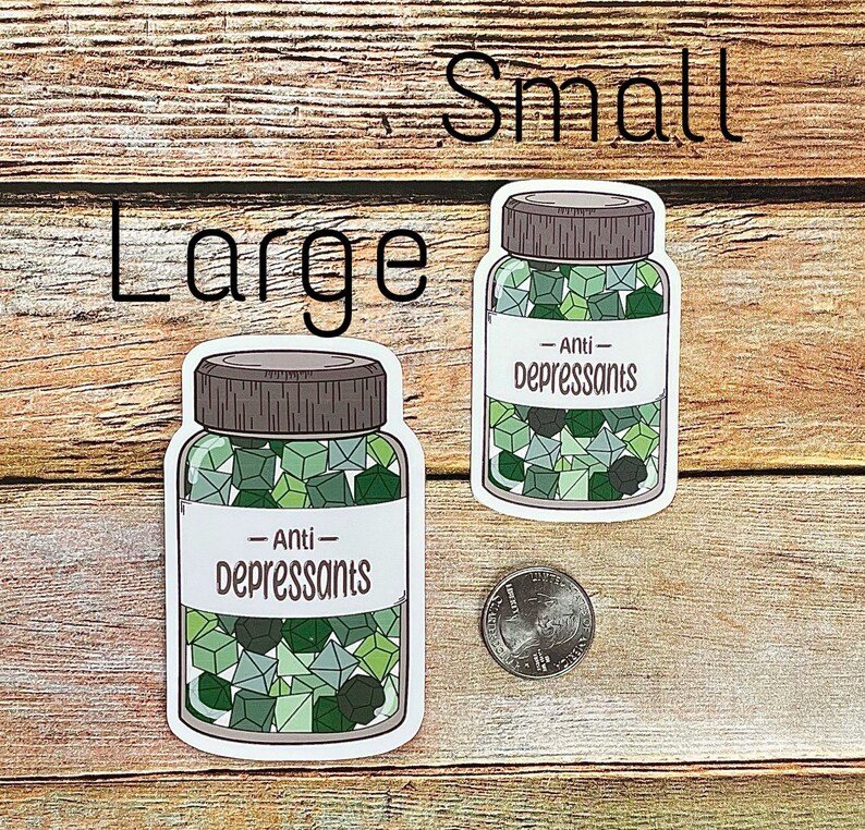 May include: Two stickers, labeled "Large" and "Small", depict jars filled with green and gray geometric shapes. The labels on the jars read "Anti-Depressants". A quarter is next to the smaller jar. The background is a wooden surface.