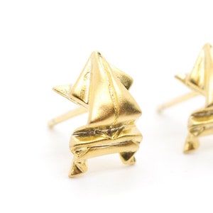 Può includere: Un paio di orecchini in oro in stile origami. Gli orecchini sono realizzati in metallo piegato e hanno un design geometrico.