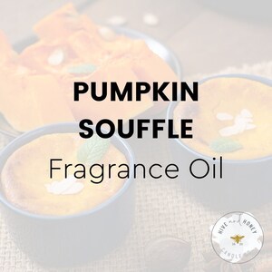 May include: Pumpkin Souffle Fragrance Oil by Hive and Honey Candle Co.  A close-up of three small, round, yellow pumpkin souffle desserts in black ramekins. The desserts are topped with a sprig of mint and white chocolate shavings.