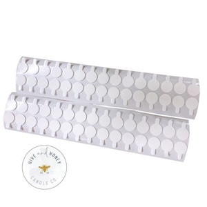 May include: Two rolls of white adhesive stickers with a small tab on each sticker. The stickers are arranged in rows on a white background. The image includes a logo for Hive and Honey Candle Co.