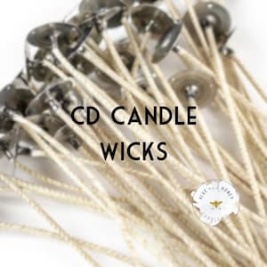 May include: Close-up of a bundle of CD candle wicks. Each wick has a metal base and a beige, braided cotton wick. The text "CD CANDLE WICKS" is displayed in black, with a small logo in the bottom right corner.