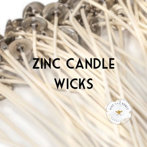 May include: A close-up of a bunch of white zinc candle wicks with silver tops. The text "ZINC CANDLE WICKS" is in the center of the image. A small white circle with a bee and the text "HIVE AND HONEY CANDLE CO." is in the bottom right corner.