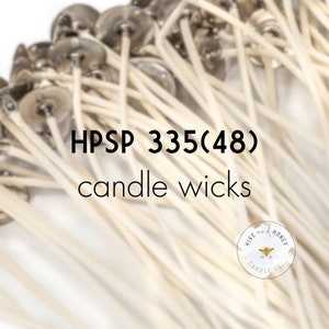 May include: A close-up of a bundle of white candle wicks with silver tops. The text "HPSP 335(48) candle wicks" is printed on a white background. A small logo for "Hive and Honey Candle Co." is in the lower right corner.