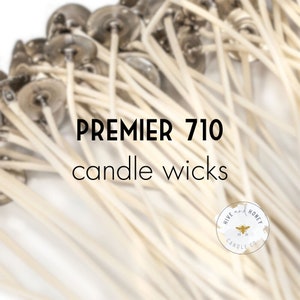 May include: A close-up of a bundle of white candle wicks with metal tops. The text "PREMIER 710 candle wicks" is in the center of the image. A small logo for "Hive and Honey Candle Co." is in the bottom right corner.