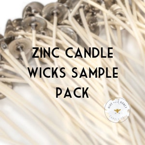 May include: A close-up of a sample pack of zinc candle wicks. The wicks are white and have a silver metal top. The text "ZINC CANDLE WICKS SAMPLE PACK" is printed in black on a white background. The logo "HIVE and HONEY CANDLE CO." is in the lower right corner.