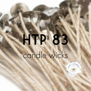 May include: Close-up of a bundle of beige candle wicks with silver tops. The text "HTP 83 candle wicks" is in the center of the image. A small white circle with the text "Hive and Honey Candle Co." is in the lower right corner.