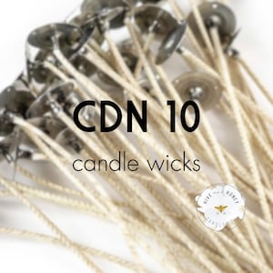 May include: A close-up of a bundle of white cotton candle wicks with metal bases. The text "CDN 10 candle wicks" is visible in the image. The image also includes a small logo with the text "Hive and Honey Candle Co."