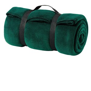 a rolled up green blanket on a white background