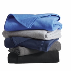 a stack of folded blankets sitting on top of each other
