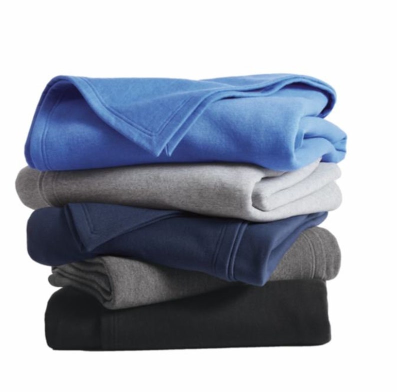 a stack of folded blankets sitting on top of each other